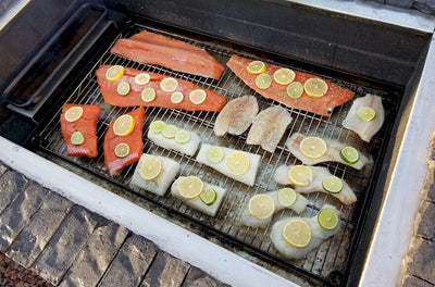 Smoking Salmon and Black Bass in a BrickWood Box using flavorful Alder cooking wood.